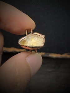 Detailed close-up of raw yellow crystal stone set in a vintage adjustable ring base