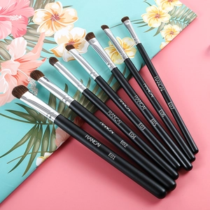 Professional 7-piece horse hair eyeshadow brush set with black handles on pink background