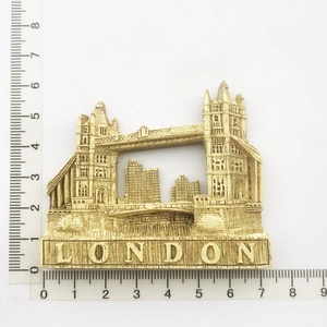 Detailed view of London Tower Bridge souvenir magnet showing dimensions with a ruler