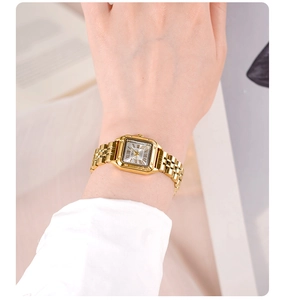 Close-up of elegant gold square watch with roman numerals on a woman's wrist