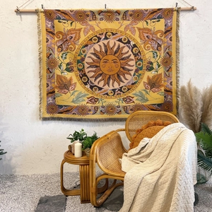 Detail of bohemian sun tapestry with zodiac symbols and cotton weave texture