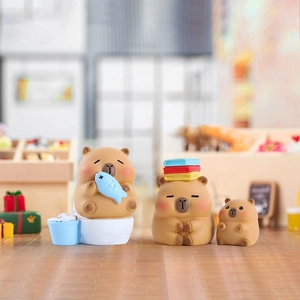 Three cute Capybara resin figurines in warm shop scene including fish and book styles