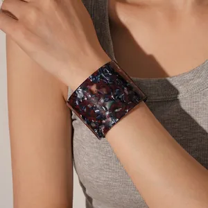 Retro vintage acetate open cuff bracelet with dark tortoiseshell pattern on woman wrist