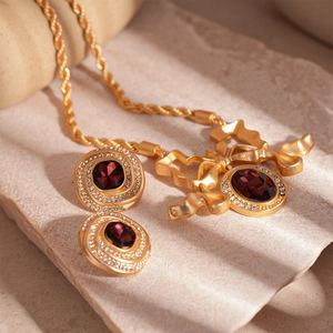 Vintage gold jewelry set with red oval gemstone and rhinestones in bowknot design