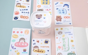 Close-up of a clear square storage box featuring a cute cartoon bear and happy quotes