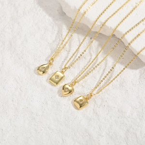 Elegant gold necklaces with geometric starburst pendants and white zircon details on stone