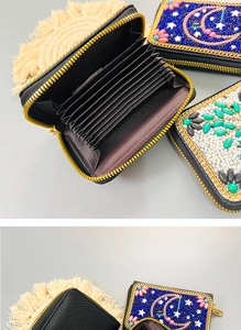 Detail of bohemian handmade beaded card holder with moon pattern and organ-style slots