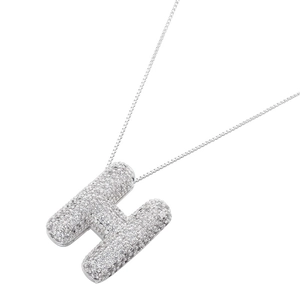 Macro detail of silver balloon initial H pendant with full cubic zirconia stones