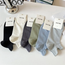 Flat lay of colorful low-cut socks with heel tabs and variety of pastel color options