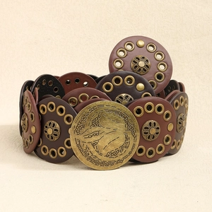 Detail of vintage brown leather disc belt with punk rivets and bronze snake buckle