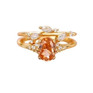 Elegant gold double-layered leaf ring set with large oval orange gem and white petals