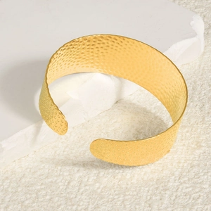 18k gold plated stainless steel open bangle featuring handcrafted hammered textures