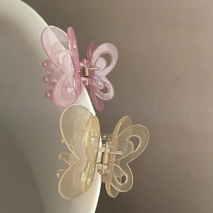 Elegant hollow butterfly hair claws in translucent pink and beige acrylic material
