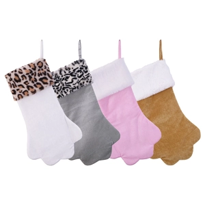 Row of plush animal paw-shaped Christmas stockings with leopard faux fur trim