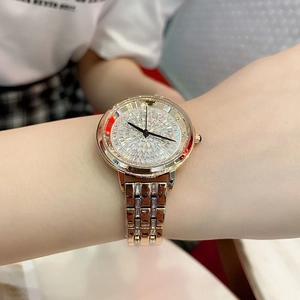 Close-up of rose gold women's quartz watch with sparkling crystals on the wrist