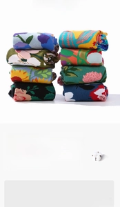 Detail of cotton crew socks showing vibrant floral art prints and fine knit texture