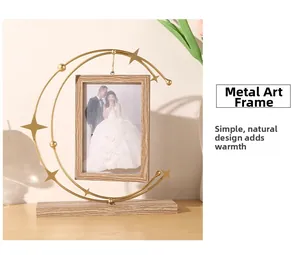 Detail view of moon and stars iron photo frame with wood texture base and wedding photo