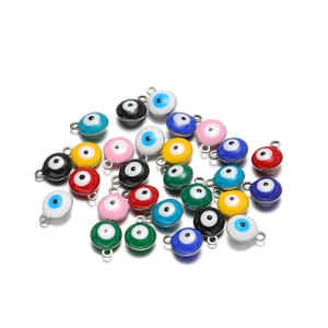 Close-up of colorful alloy evil eye charms with drip oil craft for DIY jewelry making