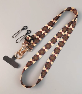 Adjustable crossbody phone strap with geometric mandala pattern and gold metal hook