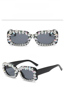 Detail view of black square sunglasses with pearl and colorful diamond rhinestones