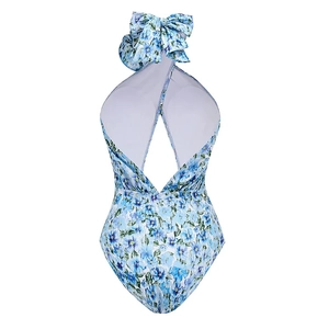 Close-up of floral print one-piece swimsuit with halter neck and large bow detail on back