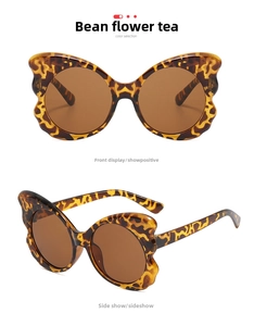 Detail view of butterfly leopard print sunglasses with stylish brown gradient lenses