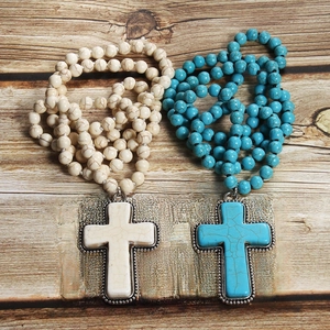 Bohemian 8mm turquoise knotted prayer necklace with cross pendant on rustic wood
