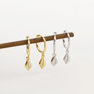 Detailed view of S925 silver shell earrings with pavé crystals in gold and silver finish