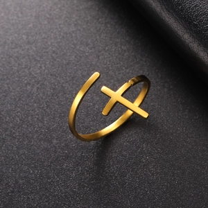 Close-up of a minimalist 18K gold plated titanium steel cross open ring on black background