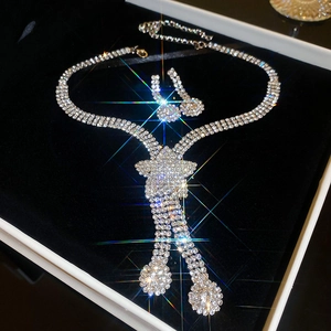 Close-up of silver rhinestone jewelry set with star necklace and earrings in a box