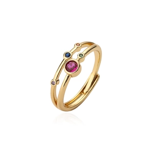 Macro detail of gold-plated double-layer open ring featuring vibrant multi-color gemstones