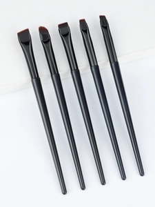 Detailed view of five black precision eyeliner and eyebrow brushes with synthetic bristles