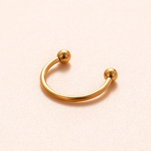 Detailed close-up of golden titanium horseshoe ring with internal thread screw balls