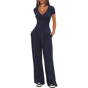 Detail of navy blue V-neck wrap top and wide-leg trousers in soft jersey knit