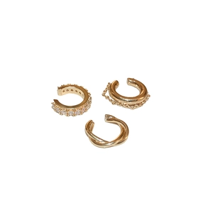 Three-piece gold ear cuff set featuring zircon pave, chain tassel, and twisted textures