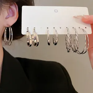 Minimalist silver hoop earring set featuring polished, flat, and twisted rope designs