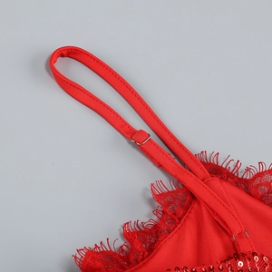 Detail of red sequin dress featuring adjustable straps and delicate lace trim accents