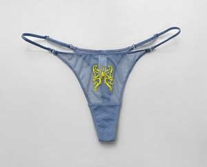 Detailed close-up of yellow butterfly embroidery on blue sheer mesh thong underwear