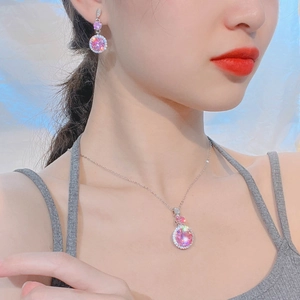 Close-up of pink zircon jewelry set including necklace and earrings on a model