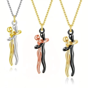 Detailed view of three hugging couple pendants in silver, gold, rose gold and black finishes