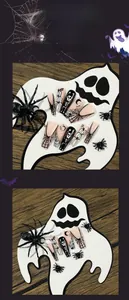 Detail of Halloween press-on nails featuring hand-painted pumpkin and spider web designs