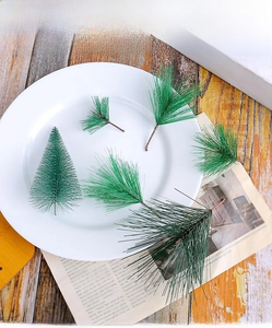 Detailed view of faux pine needles and mini Christmas tree for holiday DIY decor