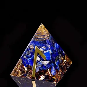 Lapis Lazuli Orgonite pyramid with gold foil and spiral metal coil on black background