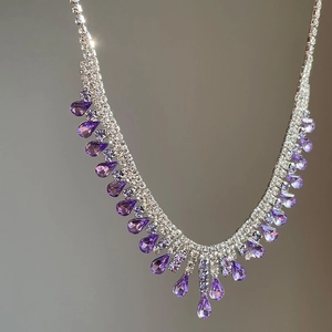 Elegant silver tassel necklace set with purple teardrop crystals and sparkling rhinestones