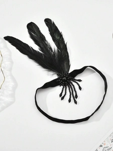Detail of 1920s vintage black feather headband with elegant beads and sequins