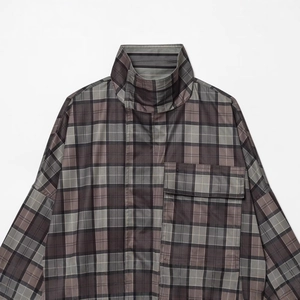 Women's plaid trench coat with dark gray pattern, high collar, and chest flap pockets