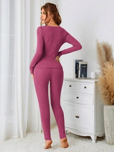 Detail of ribbed knit magenta loungewear set showing the slim fit from the back view