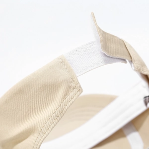 Detail of adjustable hook-and-loop strap on a beige cotton sun hat for women