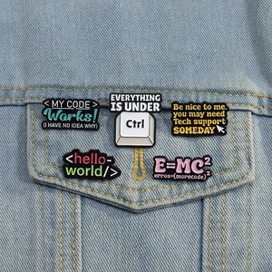 Five math and coding enamel pins set on a denim jacket pocket showing nerdy slogans