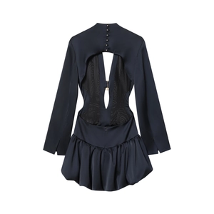 Mini robe noire chic avec dos nu et boutons dorés sur fond blanc, style contemporain